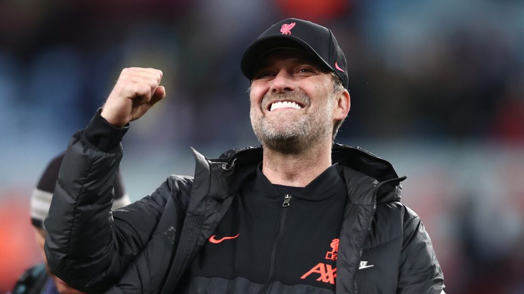 Imagem do treinador Jürgen Klopp sorrindo e com braço direito levantado em sinal de comemoração. Klopp é o técnico escolhido para montar nossa seleção.